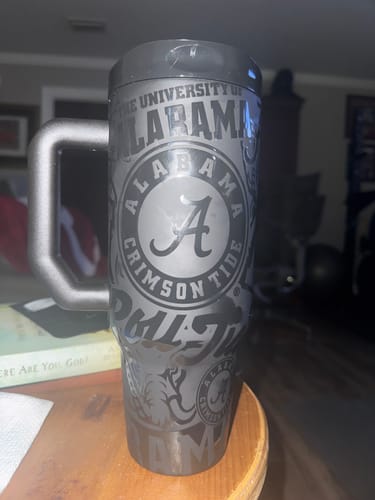 Customer's gray Alabama Crimson Tide Thicc Buddy mug with handle, standing on a round table.
