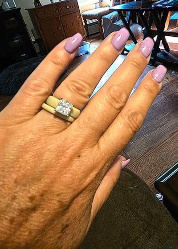 Customer's Princess Cut CZ Silicone Ring Set, featuring a square stone on a simple band worn on their finger.