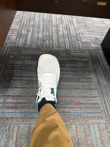 Customer's white and teal Extra Comfort Support Insoles worn inside a shoe, viewed from above.