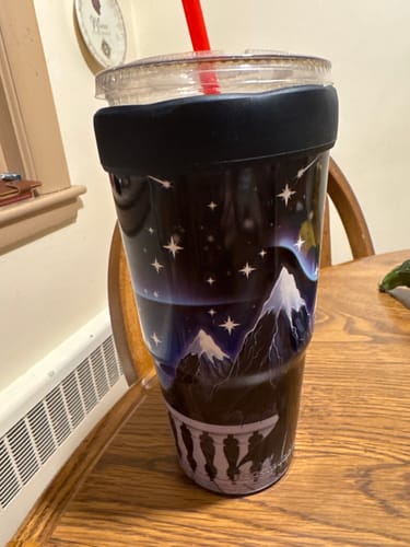 Customer's To-Go Buddy Nightfall cup featuring a mountain and star design on a wooden table.