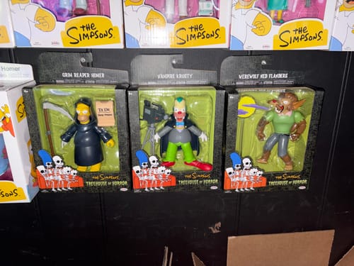 Customer's Grim Reaper Homer, Vampire Krusty, and Werewolf Ned Flanders figures in The Simpsons Treehouse of Horror boxes.