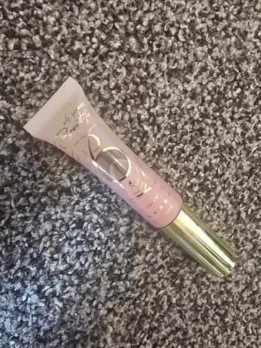 Customer's Babyccino Clear Eyebrow Gel tube with pink cap lying on a textured grey carpet.