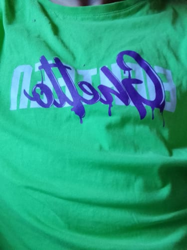 Customer's neon green t-shirt with purple graffiti-style lettering across the chest.