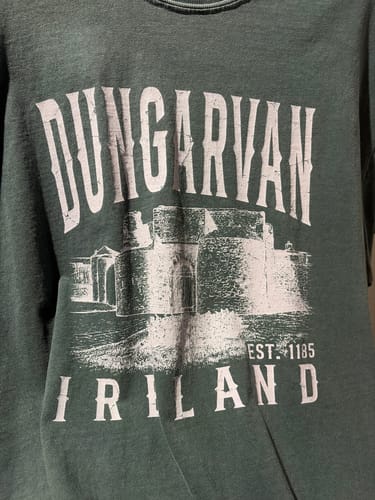 Customer's green Dungarven Ireland Sketch T-Shirt showing a white printed sketch of a castle and Ireland text.