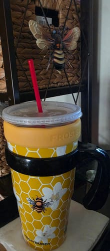 Customer's To-Go Buddy cup featuring yellow honeycomb pattern with bee icons, set in a cup holder.