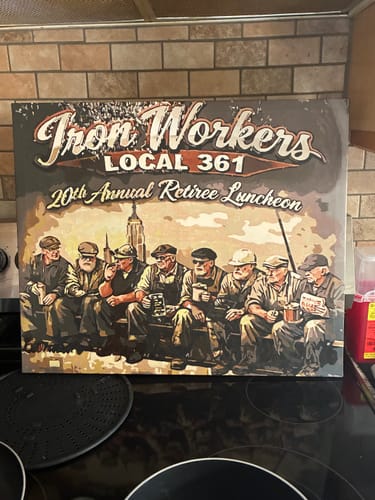 Customer's Custom Paint By Numbers portrait on a wall, showing a group of retired iron workers sitting on a bench.