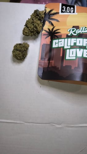 Customer's California Love THC-A flower buds next to the brand's resealable packaging.