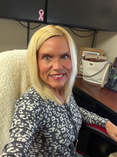 Customer's Deep Collagen Cream user showing smooth skin while sitting in an office chair.