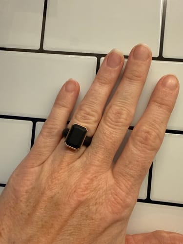 Customer's Rinfit Emerald Collection silicone ring with a black rectangular stone on their finger.