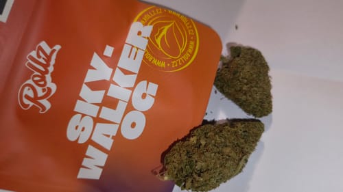 Customer's Skywalker OG CBD flower buds next to the orange product pouch