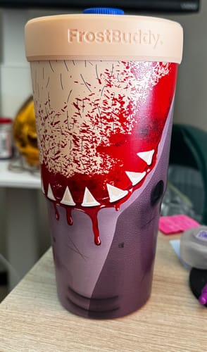 Customer's To-Go Buddy tumbler featuring a graphic of monster teeth and blood on a wooden table.