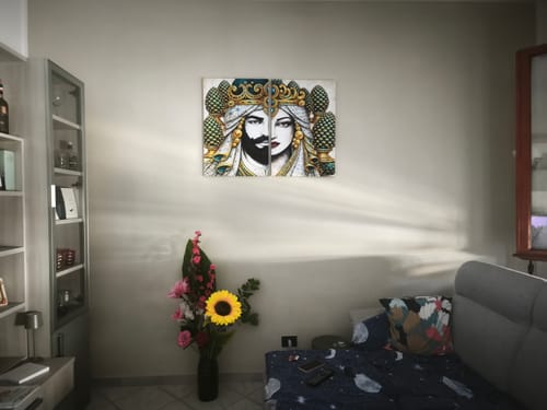 Customer's La Mora Regale wall art hung as a diptych in a cozy living room with a flower vase nearby