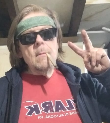 Customer's selfie wearing sunglasses and a green headband while enjoying Royal Cherry flower.