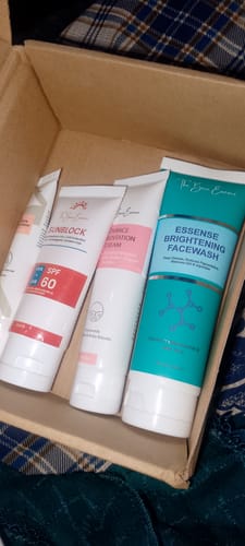 Customer's Essense Hydrating Lotion along with other skincare tubes inside a cardboard delivery box.
