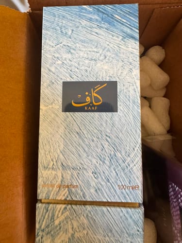 Customer's Kaaf perfume box by Ahmed al Maghribi inside a cardboard delivery box with foam packing peanuts.