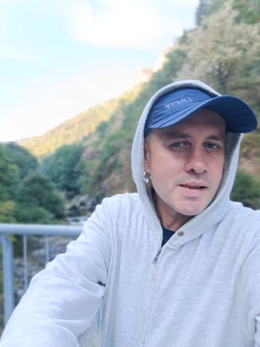 Customer's selfie wearing a hooded sweatshirt outdoors, representing their experience with the THC-A Pre-Roll Cali Blend.
