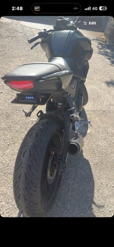 Customer's rear view of a black motorcycle showing the installed Yamaha indicator holder bracket.