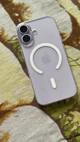 Customer's Anti Yellow MagSafe Clear Case on a light purple iPhone 17, showing the magnetic ring and camera bezel.