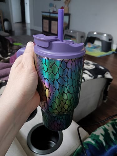 Customer's Thicc Buddy 16oz mug with iridescent snake scale pattern and a purple lid held in a hand