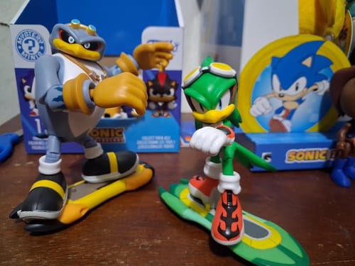 Customer's Sonic the Hedgehog 35th Anniversary Storm figure on a board next to a green figure on a board.
