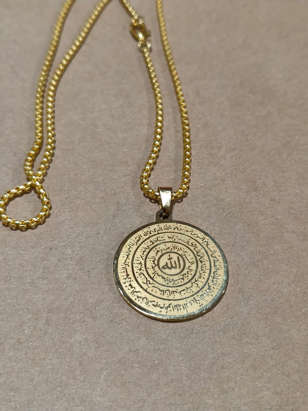 Customer photo review of HilalHaven Polished Round‑Disc with Circling Quranic‑Ayatul Kursi Verse Allah Necklace