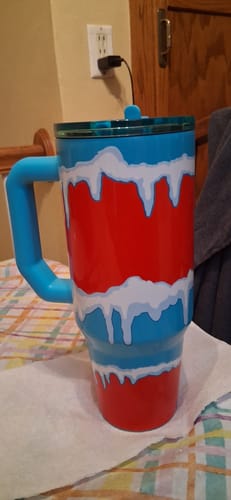 Customer's Mystery Thicc Buddy tumbler with a blue handle and a red and blue drip pattern.