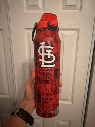 Customer's hand holding a red St. Louis Cardinals Bottle Buddy with bold white logos.