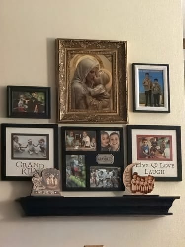 Customer's Grandma Grandkids on Moon wooden plaque displayed on a shelf among family photos.