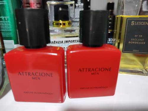 Customer's Attracione Men pheromone perfume bottles, two red square bottles side-by-side on a shelf.