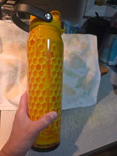 Customer's yellow honeycomb patterned Bottle Buddy held in hand.