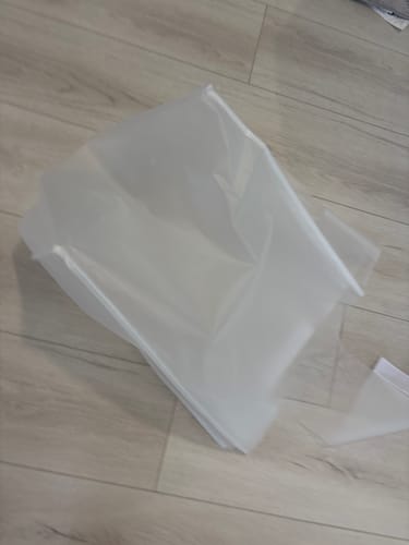 Customer's Luggage Cover spread out on a wooden floor