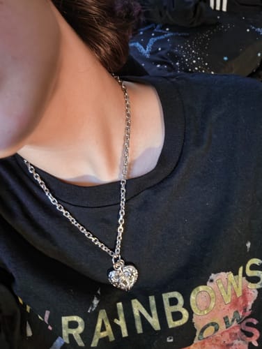 Customer's silver Aries Chain necklace worn with a heart-shaped pendant, showing the link style.