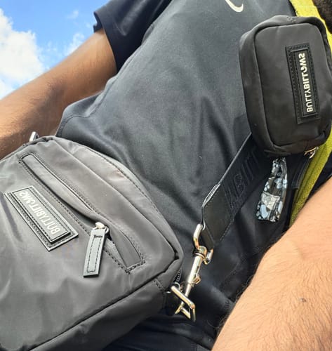 Customer's black BullyBillows dog walking bag worn across the chest, featuring a small matching pouch and strap.