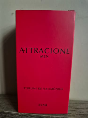 Customer's Attracione Men perfume box in bright pink, sitting on a wooden surface.
