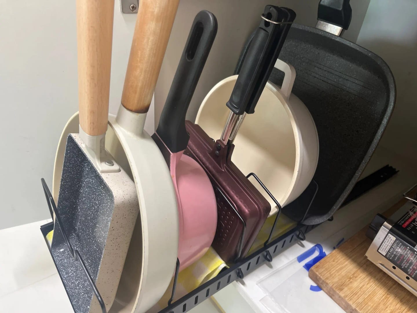 Customer photo review of Under-Cabinet Sliding Pots and Pans Organizer with 8 Adjustable Dividers