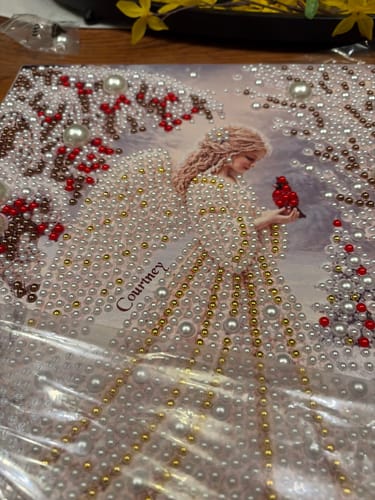 Customer's Personalized 3D Pearl Art canvas featuring an angel, bird, and the name Courtney, partially covered in plastic