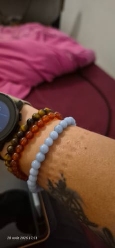 Customer's light blue Bracelet Angélite on their wrist, worn alongside two other beaded bracelets.