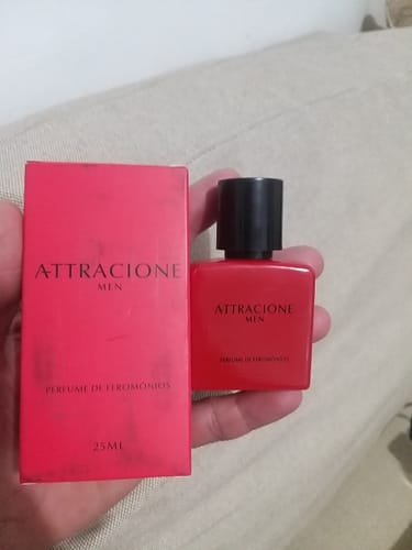 Customer's Attracione Men perfume bottle and red box held in hand.