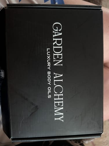 Customer's black Garden Alchemy luxury body oils box with white text