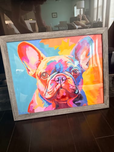 Customer's completed Frenchie's Soul colorful Frenchie paint-by-numbers artwork, in a wooden frame on a floor.