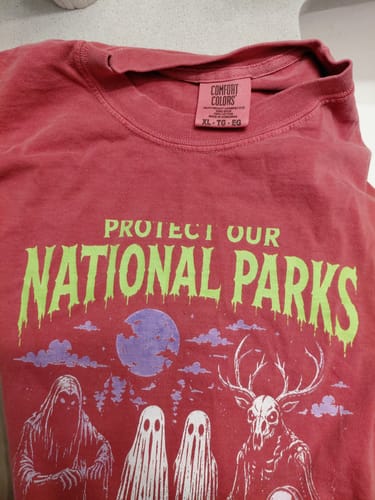 Customer's red Haunt Your Backyard t-shirt with screen-printed spooky graphics and text.