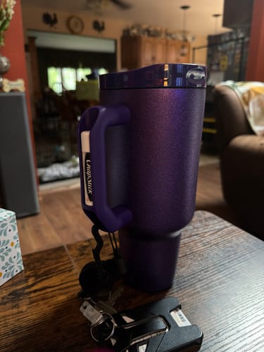 Reviewer's purple Thicc Buddy mug on a table, featuring a chapstick holder with keys attached to the handle.