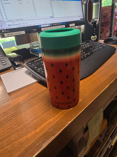Customer's Universal Buddy Mystery cup featuring a fun watermelon design, sitting on a wooden desk.
