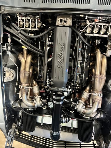 Customer's RIFE Back Pressure Canister Kit installed in an engine bay with stainless hardlines and a mounting bracket.