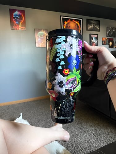 Customer's Toxic Bloom Thicc Buddy mug with floral and ghost print being held in a hand.