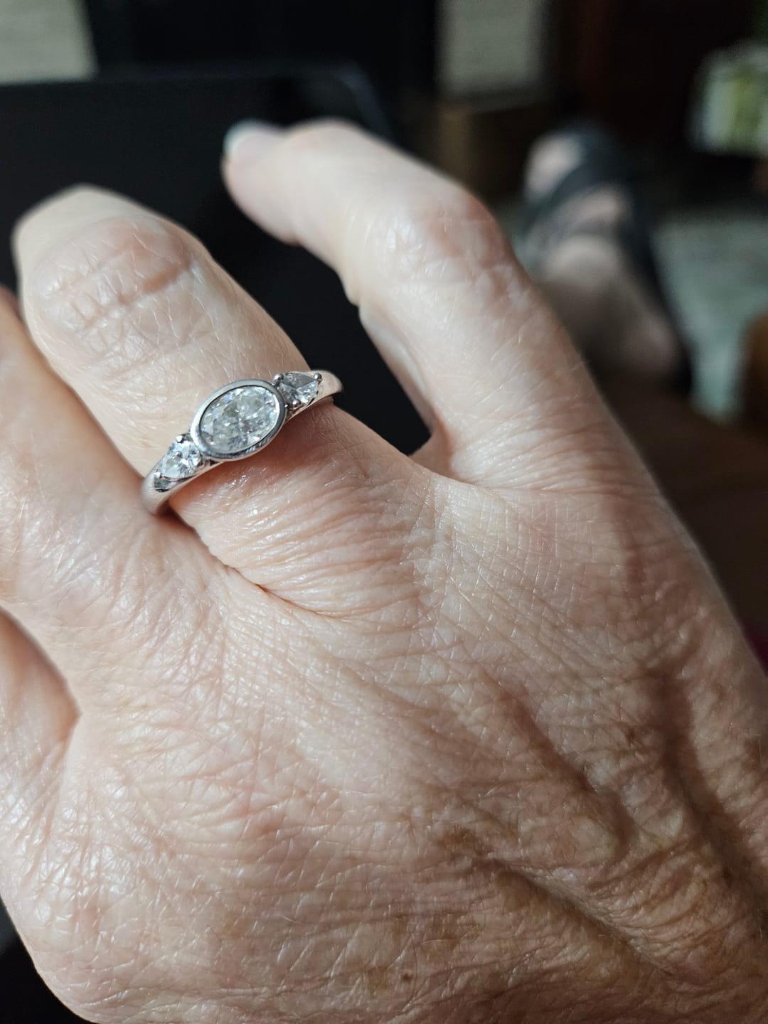 Customer photo review of Three-Stone East-West Bezel Oval Moissanite and Pear Sapphire Engagement Ring