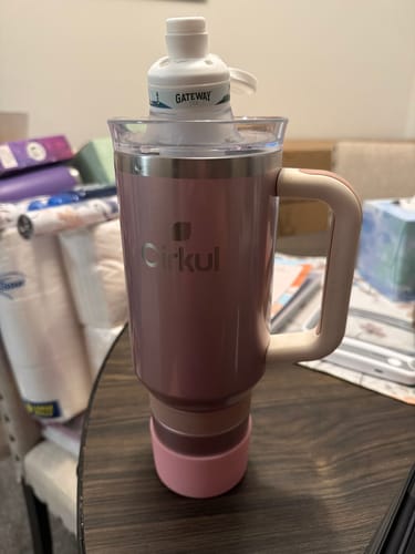 Customer's pink Cirkul tumbler with a white Gateway flavor cartridge attached, sitting on a wooden table.