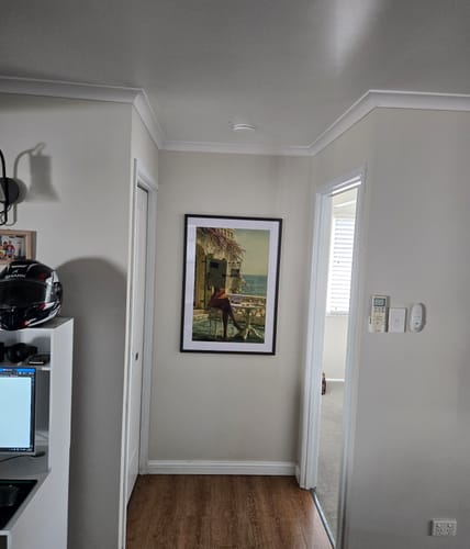 Customer's framed La Dolce Niente N02 art print hanging on a neutral hallway wall.