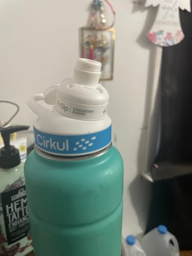 Customer's turquoise water bottle with a white Cirkul Strawberry Banana flavor cartridge attached.