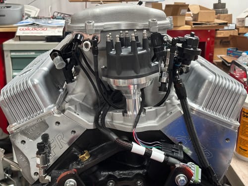 Customer's RIFE IAT sensor mounted on the back of a silver intake manifold on a V8 engine.